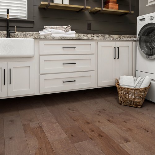Kitchen with a basket of laundry on engineered hardwood flooring from Brennan's Carpet in Hailey, ID