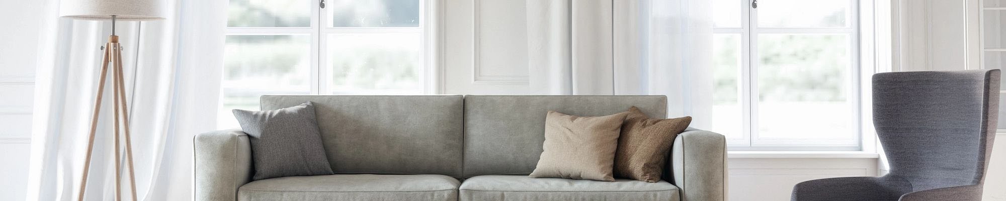 Living room with a gray couch and area rug on hardwood flooring from Brennan's Carpet in Hailey, ID