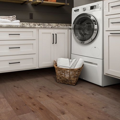 Kitchen with a basket of laundry on engineered hardwood flooring from Brennan's Carpet in Hailey, ID